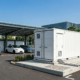 An outdoor containerized 1MW battery storage for EV charging stations installed on a concrete foundation pad.