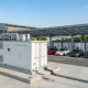 An outdoor 1MW battery storage system enclosure integrated at an EV charging site.