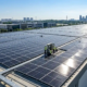 High-efficiency industrial solar panels installed on a flat roof for commercial rooftop solar systems.