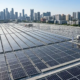 High-efficiency industrial solar panels installed on a flat roof for commercial rooftop solar systems.