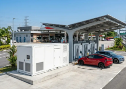An outdoor battery energy storage for EV charging stations system integrated next to high-power dispensers.