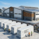 A heavy-duty containerized industrial bess installed alongside a modern manufacturing facility to reduce peak demand charges.