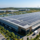 A massive commercial solar PV array installed by a professional industrial solar solutions construction company on a factory roof.