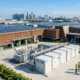 Premium outdoor battery energy storage solution integrated with roof solar panels, highlighting solar storage batteries for sale for industrial parks.