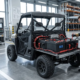 Engineer testing how fast is a 72V battery on an electric utility vehicle in a modern workshop