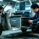 Technicians evaluating an electric tricycle battery capacity and mounting setup on a commercial cargo trike